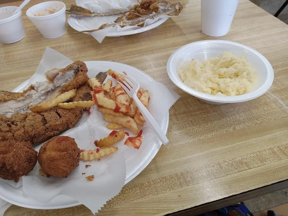 Catfish Fries Cheese Grits and Hush Puppies
